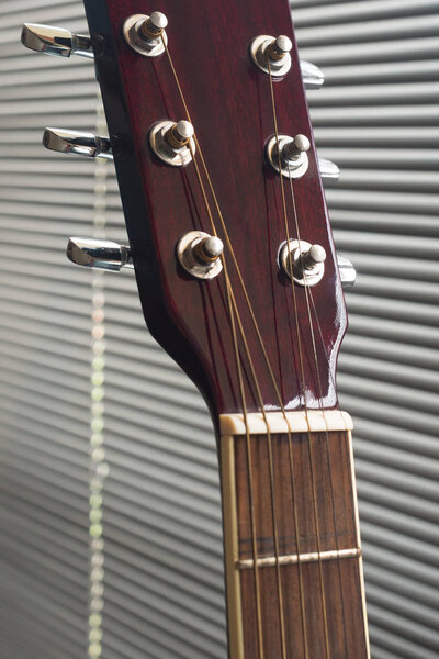 Close up to the tuning keys of an acoustic guitar