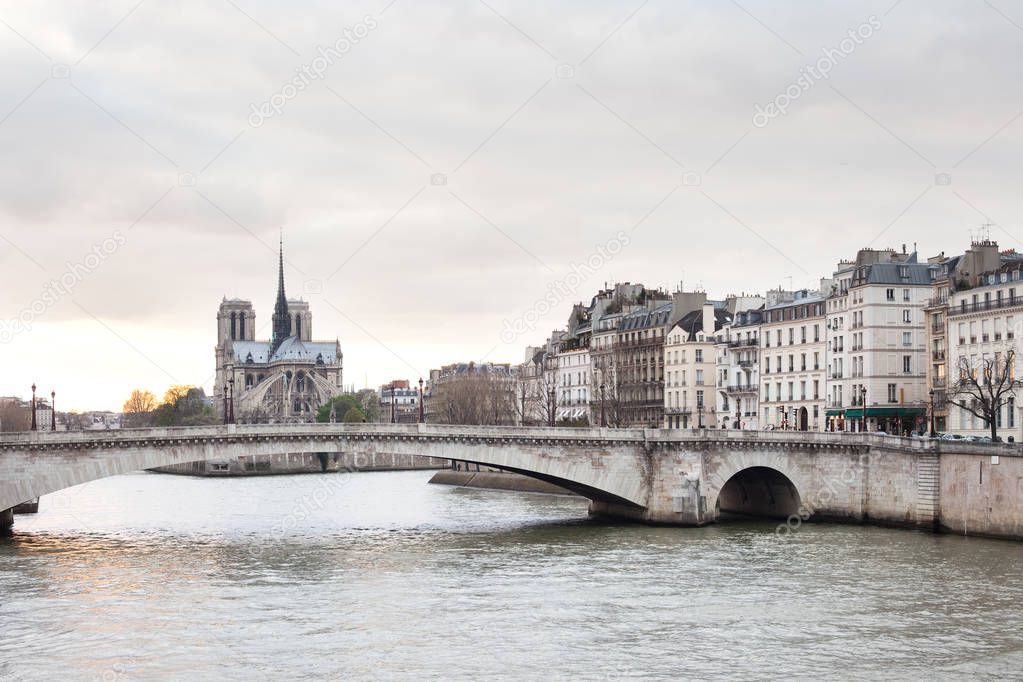 Apartments on Ile Saint Louis, Notre Dame Cathedral on Ile de la Cite and Pont de la Tournelle over Seine river, Paris, France