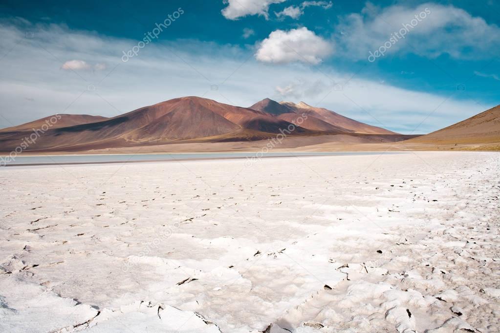 Tuyajto lagoon and salt lake in the Altiplano (high Andean plateau) over 4000 meters over the sea level with salt crust in the shore, Los Flamencos National Reserve, Atacama desert, Antofagasta Region, Chile, South America