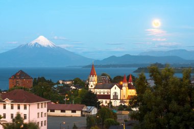 Moon rising on Puerto Varas at the shores of Lake Llanquihue with Osorno Volcano in the back, X Region de Los Lagos, Chile clipart