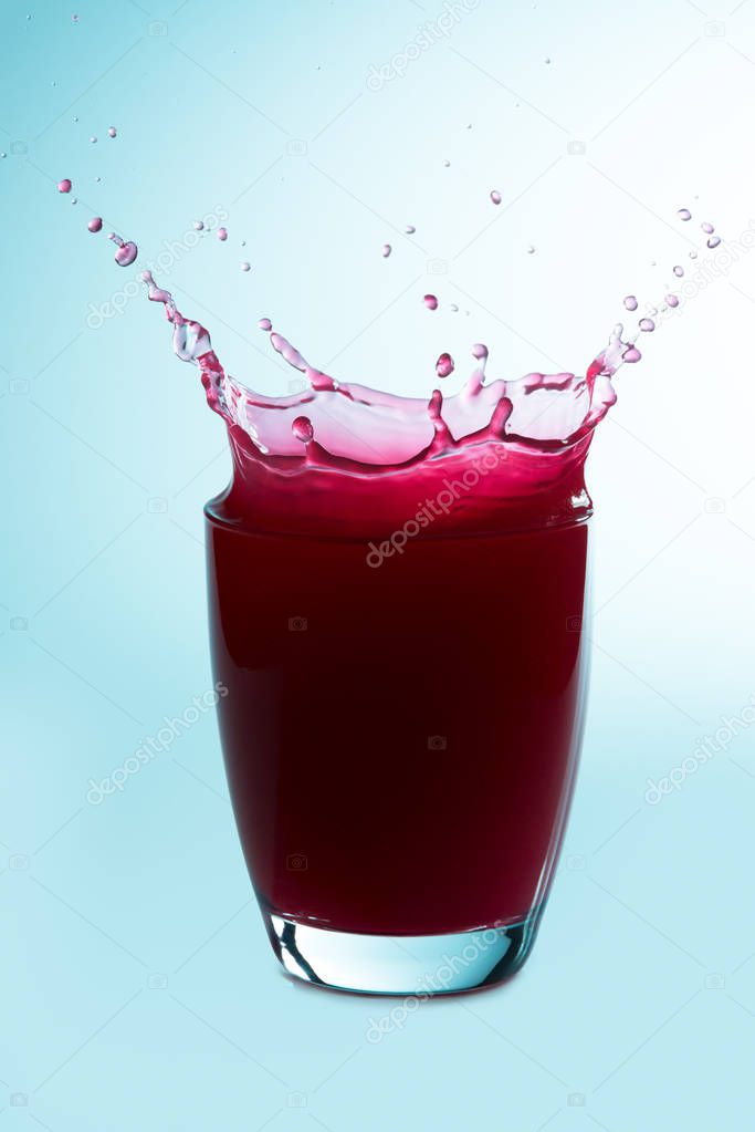 Splash on a glass of raspberry juice
