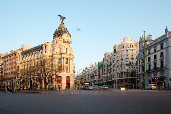 Madrid, Spain - April 5, 2010: Gran Via and the iconic Metropolis Building sourrounded by trational spanish architecture at sunrise