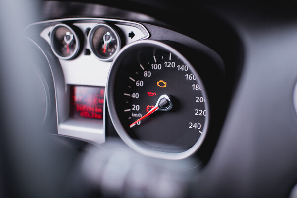 Close up shot of a speedometer in a car