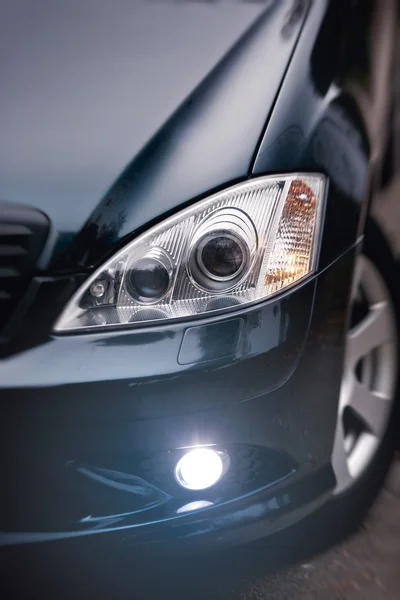 Headlights of dark blue car. — Stock Photo, Image