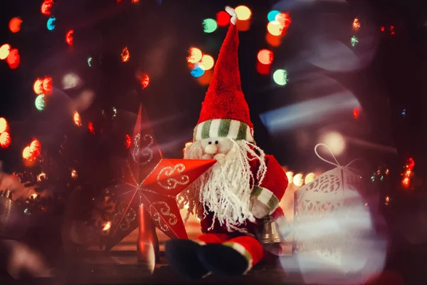 Santa Claus with Christmas star on blurred lights background