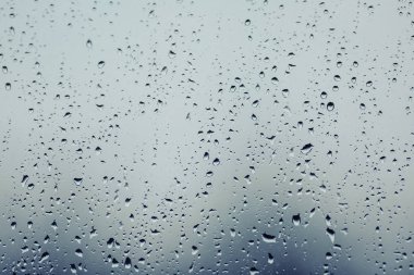 Close up of water droplets on glass. Window with rain drops. 