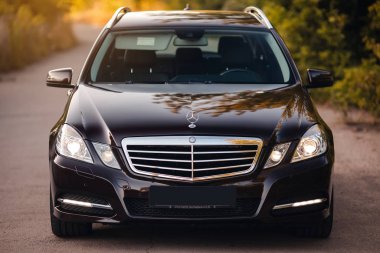 Stuttgart, Germany - January 28, 2020: Original Mercedes E-class W212 Touring Wagon, avantgarde, Mercedes logo, front light.