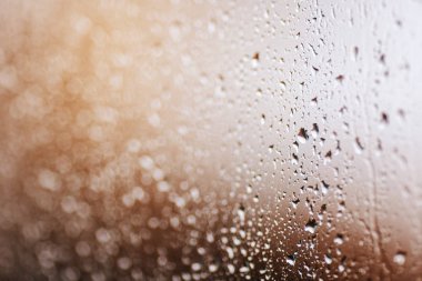 Close up of water droplets on glass. Window with rain drops.