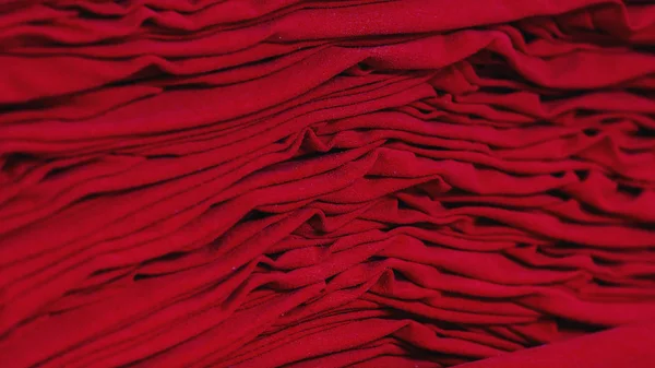 Material on the textile factory. Red cloth clothing texture material textile pattern background.