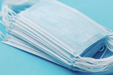 Medical mask, Medical protective masks on blue background. Disposable surgical face mask cover the mouth and nose. Healthcare and medical concept.