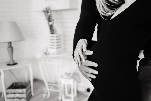 Man holds his hand on the stomach of a pregnant wife. — Stock Photo, Image