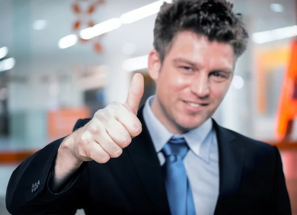 Happy handsome business man holding thumbs up — Stock Photo, Image