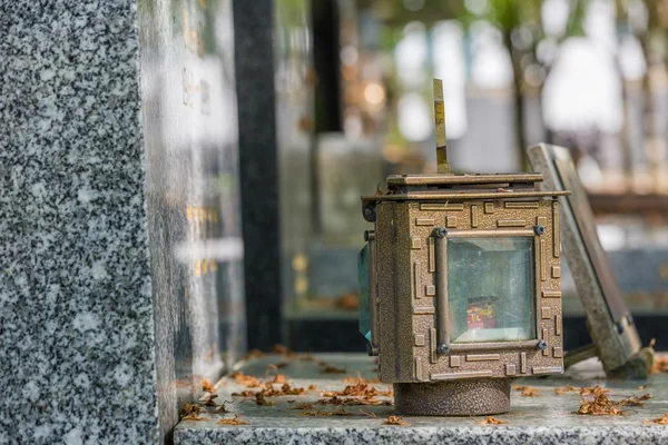 Candle lantern on the stone grave — Stock Photo, Image