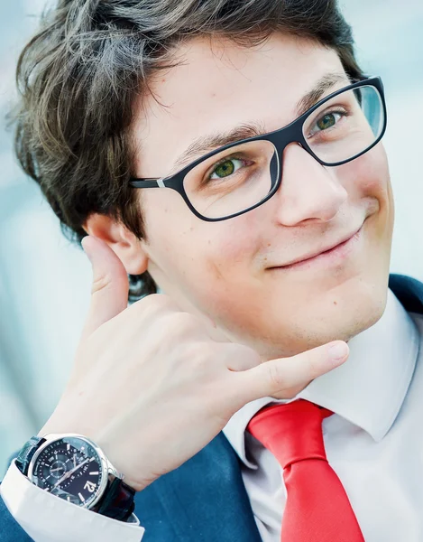 Young businessman gesturing call phone — Stock Photo, Image