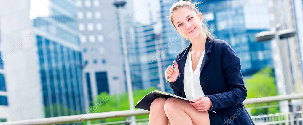 dynamic young executive taking notes on her agenda