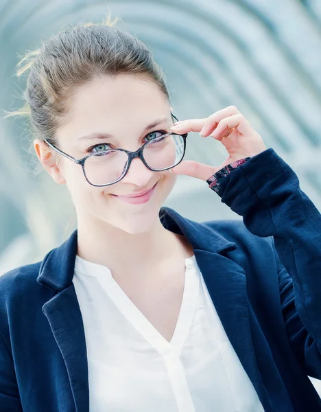 Blonde girl with glasses standing outdoor — Stock Photo, Image