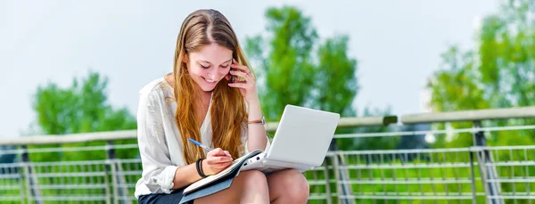 dynamic young executive taking notes on her agenda