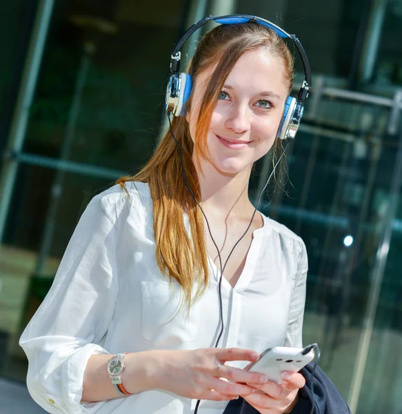 Счастливая бизнесвумен слушает музыку — стоковое фото