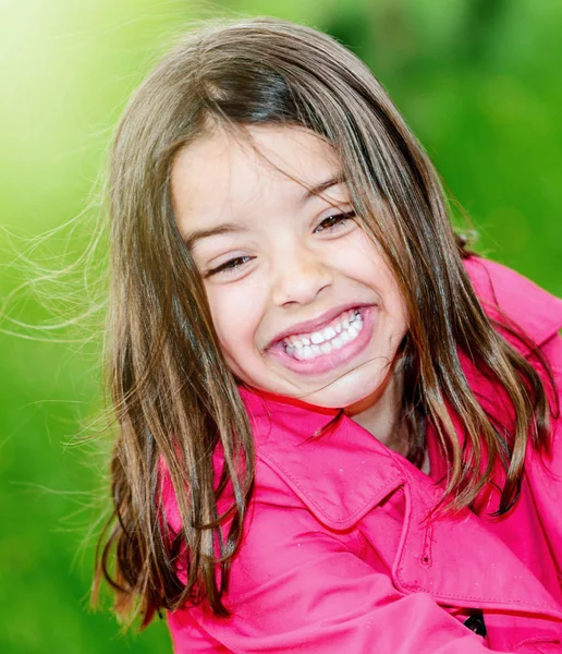 Cute child with flower garden on background — Stock Photo, Image