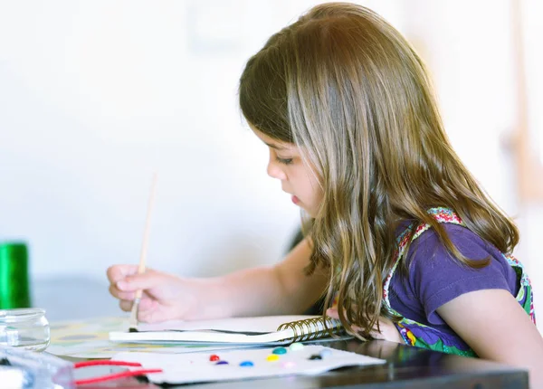 Ritratto di bella ragazza concentrata mentre dipinge — Foto Stock