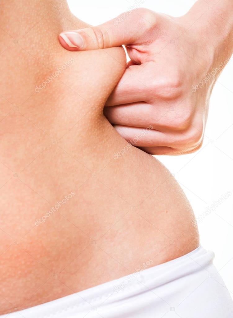 Close up woman pinching skin of her hip