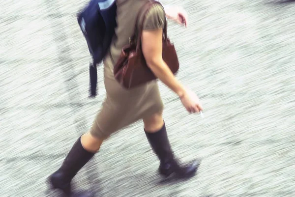 Blurry to view of woman walking in a street — Stock Photo, Image