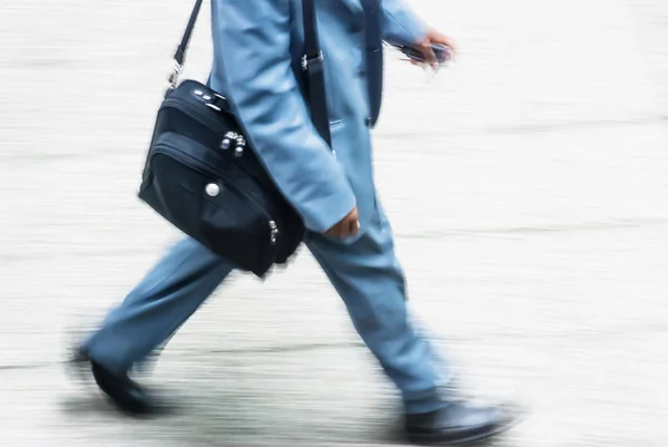 Blurry to view of businessman walking in a street — Stock Photo, Image