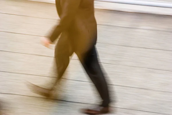 Blurry to view of man walking in a street — Stock Photo, Image