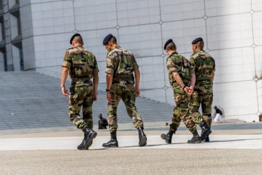 La defense, France - Mai 12, 2007: French military patrol assigned to the surveillance of a business district near Paris. These troops ensure the safety of the citizens and are there in prevention of  clipart