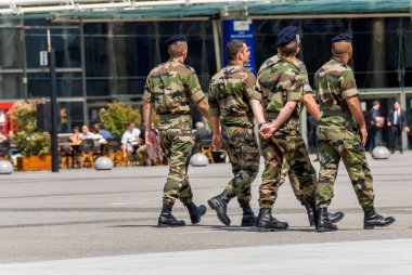 La defense, France - Mai 12, 2007: French military patrol assigned to the surveillance of a business district near Paris. These troops ensure the safety of the citizens and are there in prevention of  clipart