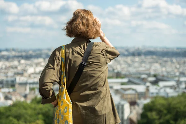 Paris, France- June 30, 2013: girl standing alone watching monuments of paris from the top of the montmartre hill — Stock Photo, Image