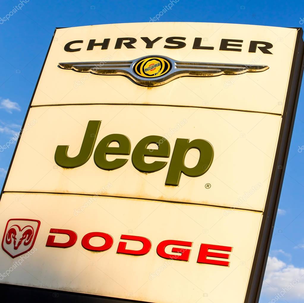 La rochelle, France - August 30, 2016: Official dealership sign of Chrysler, Jeep, and Dodge against the blue sky. American brand of cars, minivans, and sport utility vehicles manufactured by FCA US LLC
