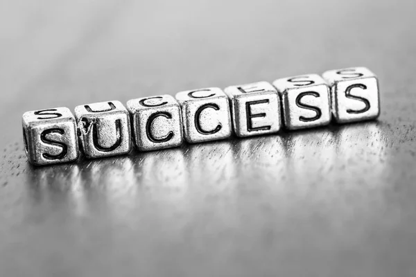 Success letters placed on a desk in precious wood — Stock Photo, Image