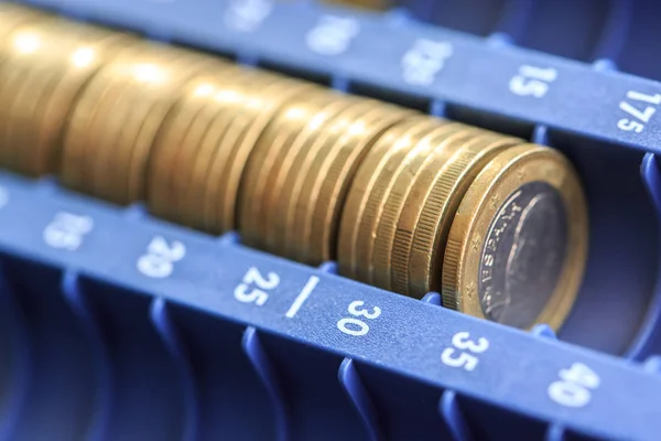 Open cash registrer containing many coins of euros in raw — Stock Photo, Image