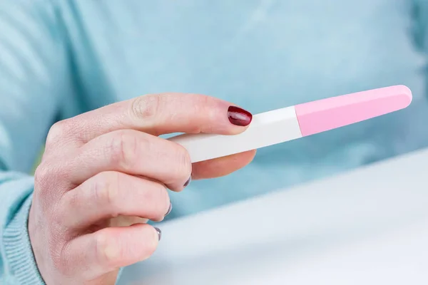 Young woman holding a Pregnancy Test in her hands — Stock Photo, Image