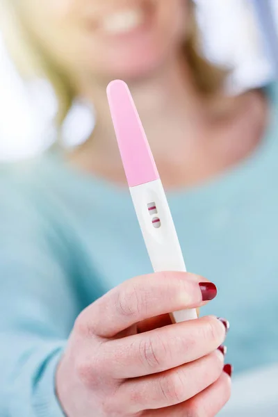 Pregnancy test positive result smiling woman — Stock Photo, Image