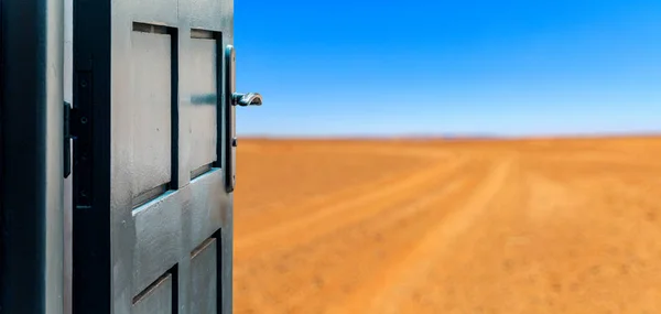Opened door concept to beautiful and imaginary desert landscape — Stock Photo, Image