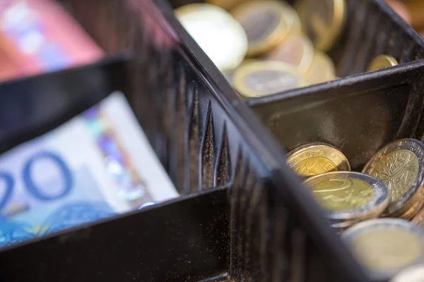 Open cash registrer containing many coins of euro ans banknotes — Stock Photo, Image