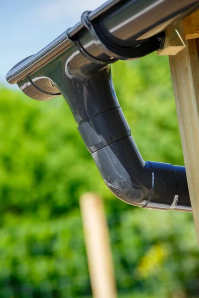 Eine Regenrinne mit grünem natürlichen Hintergrund — Stockfoto