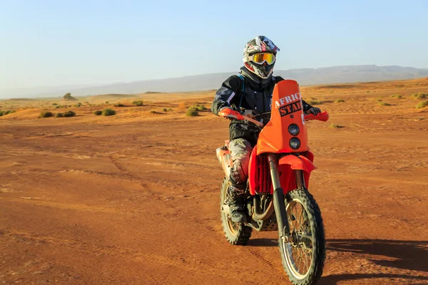 AIT Saoun, Fas - 22 Şubat 2016: Kask binicilik bisiklet AIT Saoun çöl Fas tanımlanamayan erkekte.