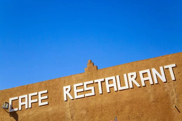 Cafe restaurant board on brick wall — Stock Photo, Image