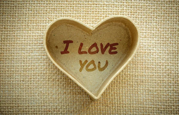 Heart with I love you word isolated on a burlap fabric. Valentines Day and love concept