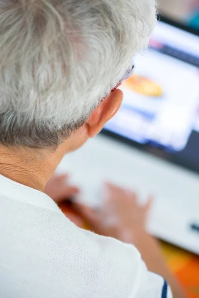 Old person with a blurred laptop image — Stock Photo, Image