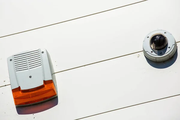 Close up on a security alarm box and cctv on a wall — Stock Photo, Image