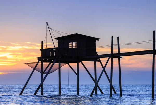 Beautiful view of fishing huts at sunset over the Atlantic Ocean — Stock Photo, Image