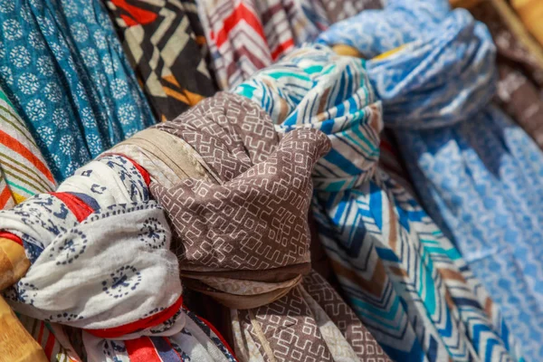 Bufandas y cheiches colgados en una tienda para vender —  Fotos de Stock