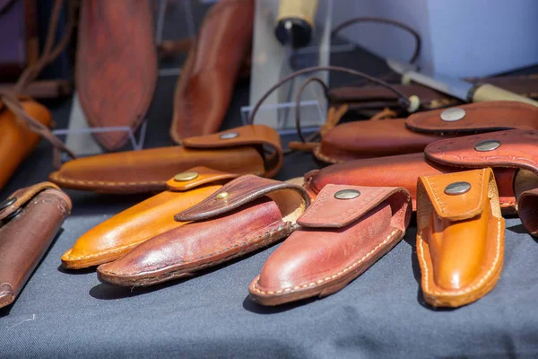 Closeup of hand tooled leather pocket knife cases or sheaths. — Stock Photo, Image