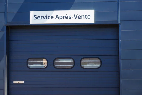 Sign over rollup door - After Sales Service — Stock Photo, Image