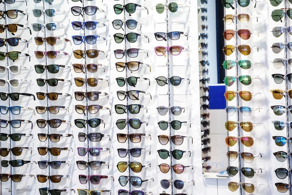 Racks of sunglasses on display in an eyewear store. — Stock Photo, Image