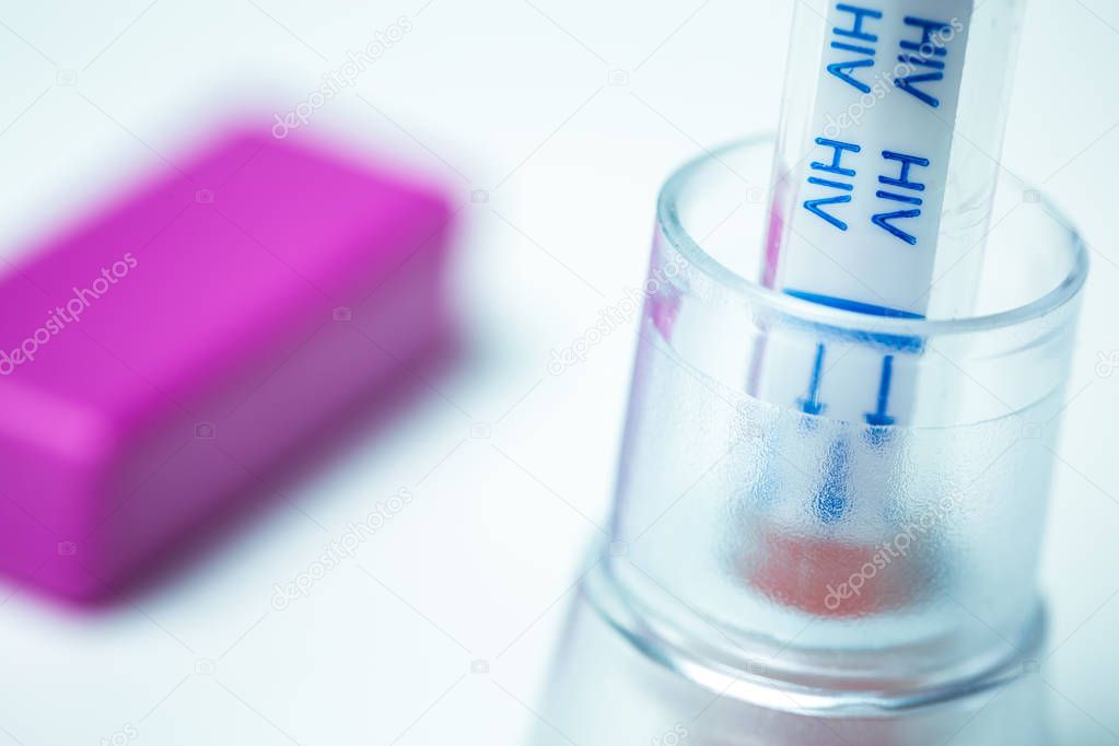 HIV self-test and its lancing device on white background